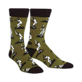A pair of men's crew socks in olive green with a repeating pattern of white baseball players batting. The socks have black cuffs.