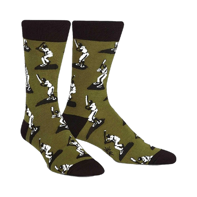 A pair of men's crew socks in olive green with a repeating pattern of white baseball players batting. The socks have black cuffs.