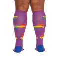 Back view of the socks on a person's legs; showcases the sock's full design and fit.