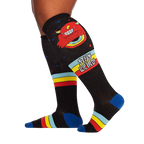 Lifestyle shot of a person wearing the 'Stay Weird!' knee-high socks, showcasing the socks' design and fit.