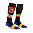 Pair of black knee-high socks with a red monster, rainbow, and retro stripes. Text reads 'Stay Weird!'