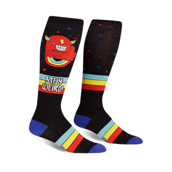 black knee-high socks with a repeating pattern of red furry monster with sharp teeth, yellow horns, stars, and stripes. made for men and women.  