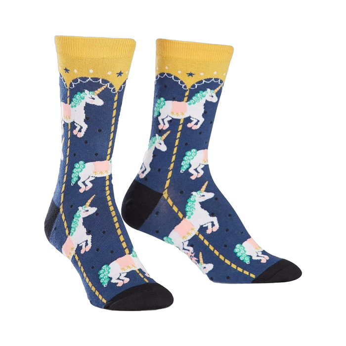 Crew socks in navy blue with a pattern of white unicorns riding a gold carousel. Yellow cuffs and pink, green details. }}