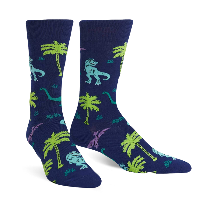 mens blue crew socks featuring green, purple, and blue dinosaurs frolicking amidst palm trees.  