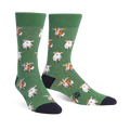 A pair of green crew socks with a repeating pattern of goats wearing bow ties. The goats are light brown and white.
