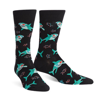 Pair of black crew socks with teal sharks wearing 3D glasses and small red fish. 