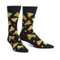 A pair of black crew socks with a fun nacho-themed design. The nachos are yellow, orange, and green, and there are also scattered jalapenos.