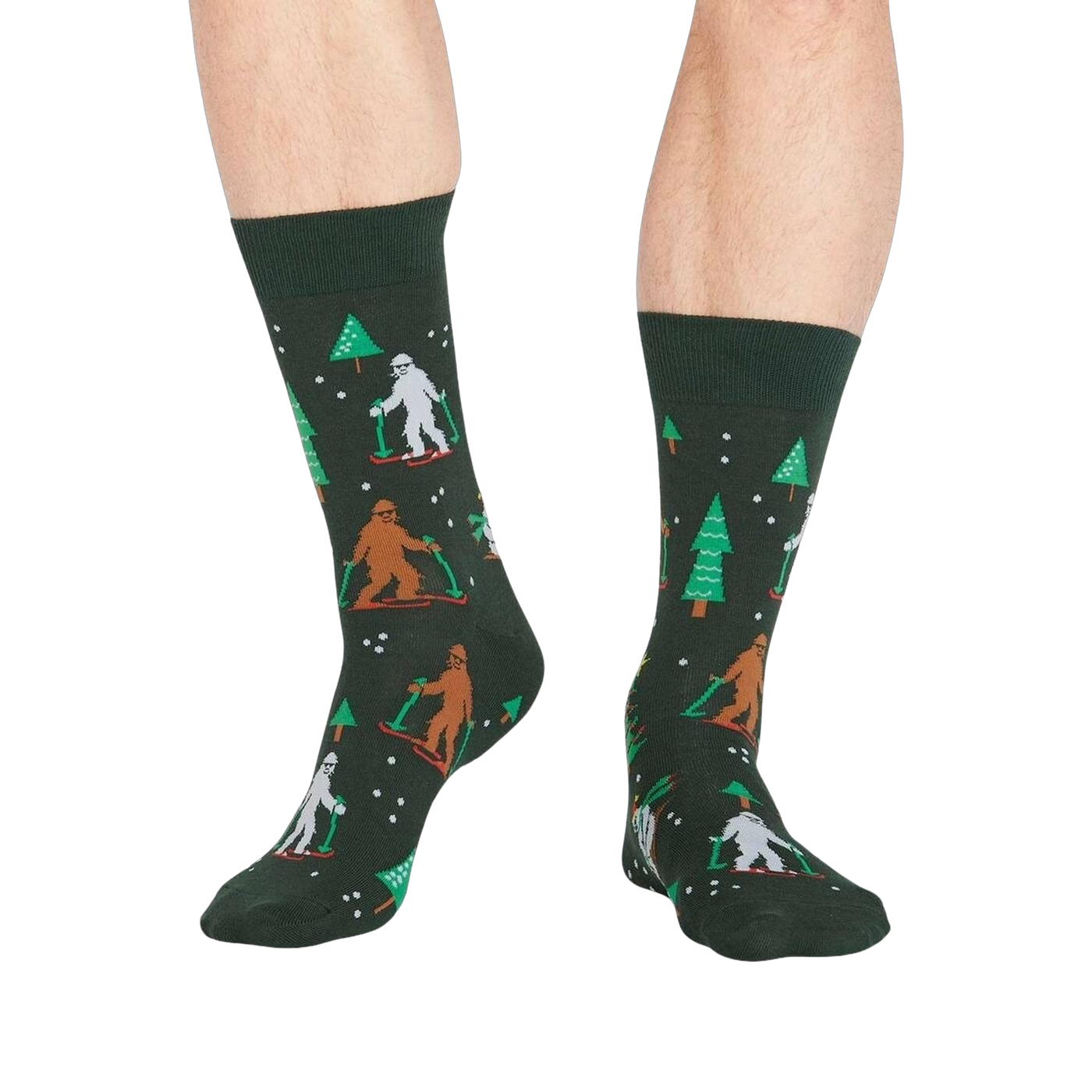 Lifestyle shot showing the 'Ready, Yeti, Go!' socks on a person's legs.  The socks are dark green with a festive pattern.