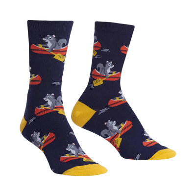 Crew socks in navy blue and mustard yellow, featuring a repeating pattern of squirrels paddling red canoes.