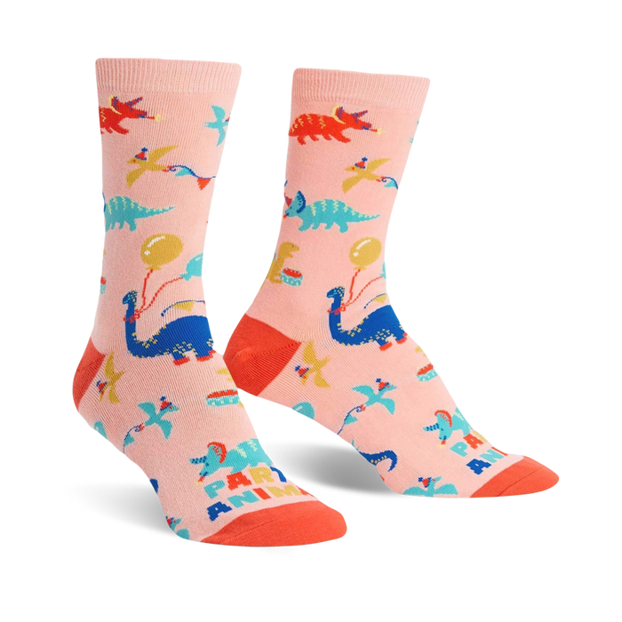 pink womens novelty crew socks with bright blue, green, and orange dinosaurs and balloons.   }}