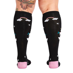 Rear view of a person wearing the 'Keep Dreamin' knee-high socks, highlighting the back design.
