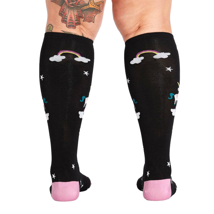Rear view of a person wearing the 'Keep Dreamin' knee-high socks, highlighting the back design.