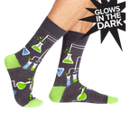 Crew socks in dark gray with a fun science design featuring beakers, flasks, and lime green accents.  They glow in the dark!