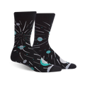 A pair of black crew socks with teal planets, shooting stars, and a celestial design.