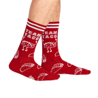 Lifestyle shot of a person wearing the red 'Team Taco' crew socks.