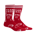 Pair of red crew socks with white stripes and a repeating pattern of cartoon tacos and the text 'Team Taco'.