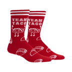 Pair of red crew socks with white stripes and a repeating pattern of cartoon tacos and the text 'Team Taco'.