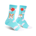 Crew socks in teal blue featuring a corgi dog attached to a red balloon, floating amongst white clouds.  The other sock displays the corgi's bottom.