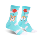 Crew socks in teal blue featuring a corgi dog attached to a red balloon, floating amongst white clouds.  The other sock displays the corgi's bottom.