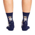 Back view of the socks on a person's legs, highlighting the full astronaut pug design on the back of the socks.
