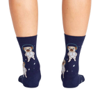 Back view of the socks on a person's legs, highlighting the full astronaut pug design on the back of the socks.
