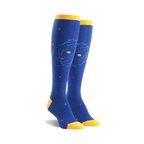 Pair of blue knee-high socks with a yellow cuff and a whimsical orbiting planet design. Small yellow stars are scattered on the sock.