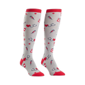 Pair of grey knee-high socks with a pattern of red hearts, stethoscopes, syringes, and medical crosses. Red cuffs.