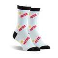 Pair of crew socks in light blue with a fun design of fried eggs and bacon strips. Black toe and heel.