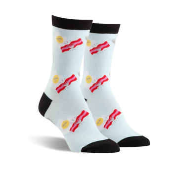 women's blue crew socks featuring stacks of bacon strips by sunny side up eggs, top of sock is black.   