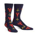 A pair of navy blue crew socks with a fun pattern of red lobsters and gold anchors. 