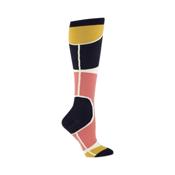 Knee-high socks in navy, dusty rose, and gold. Features a geometric Art Deco-inspired design with bold blocks of color and clean lines.
