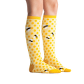 Lifestyle shot showing 'Bee's Knees' socks on a model's legs.