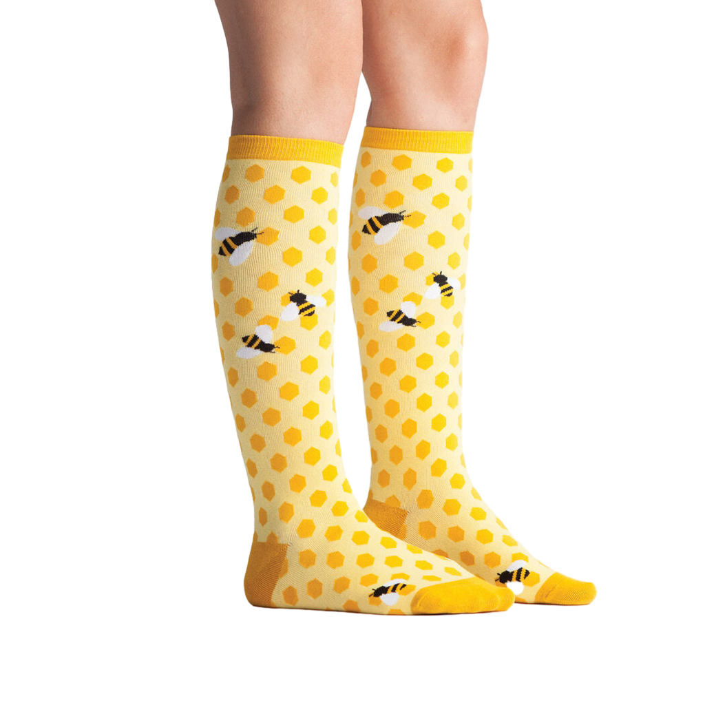 Lifestyle shot showing 'Bee's Knees' socks on a model's legs.