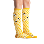 Lifestyle shot showing 'Bee's Knees' socks on a model's legs.