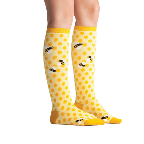 Lifestyle shot showing 'Bee's Knees' socks on a model's legs.