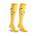 Pair of yellow knee-high socks with a honeycomb pattern and cute bee illustrations.