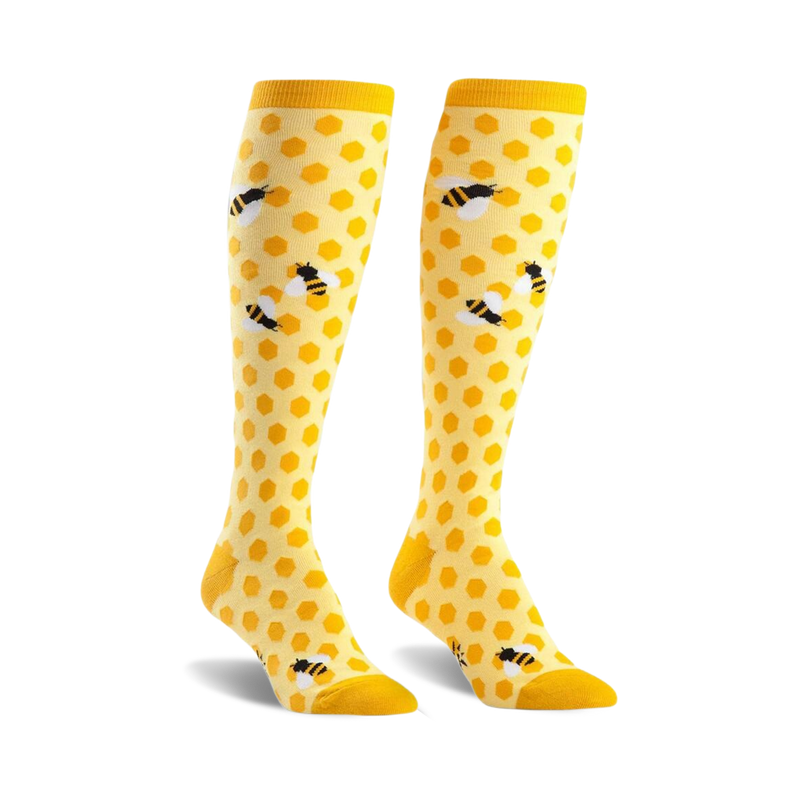 Pair of yellow knee-high socks with a honeycomb pattern and cute bee illustrations.