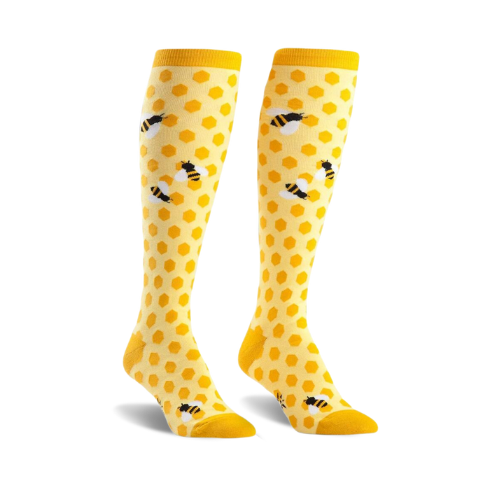 yellow knee-high socks with black bee and honeycomb pattern.  