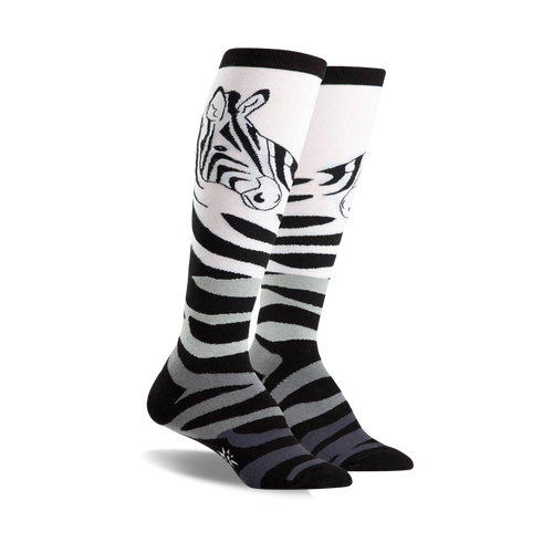 Pair of black, white, and grey zebra-striped knee-high socks.  Features a playful zebra face design near the top.