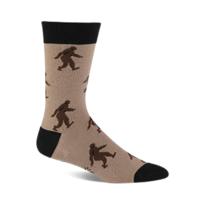 brown and black crew socks featuring a pattern of black and brown sasquatches skiing, with a black toe and heel and a tan top.  