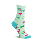 Crew socks in teal featuring pink flamingos, yellow palm trees, and turquoise vintage camper vans. Fun summer design!