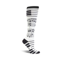 A pair of white knee-high socks with black musical notes and a piano keyboard cuff design.