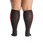 Rear view of a person wearing the black knee-high socks with red lightning bolts.