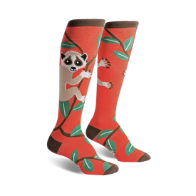 bright orange knee-high socks with a fun pattern of slow loris for women. wildlife inspired novelty socks.  