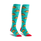 Pair of teal knee-high socks with a repeating pattern of cartoon dinosaurs made of tacos.  Accents of red on the toes and cuffs.