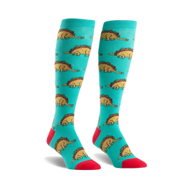 teal knee-high women's socks feature cartoon dinosaurs wearing taco shells, red toes, and light blue heels and cuffs.   