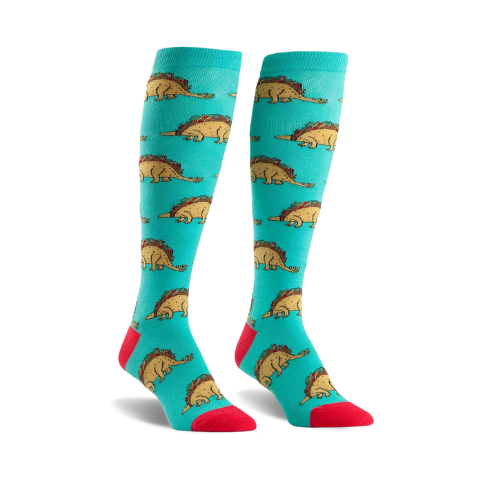 teal knee-high women's socks feature cartoon dinosaurs wearing taco shells, red toes, and light blue heels and cuffs.    }}