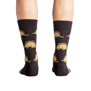 Back view of a person wearing Tacosaurus socks.  The image shows the complete sock design and a hint of the sock's cuff.