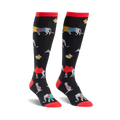 Pair of black knee-high socks with colorful animal designs including camels, elephants, and other creatures. Red tops.