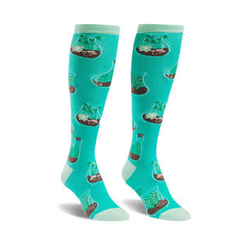 mint green knee-high socks for women featuring a pattern of terrariums with brown soil, green plants, and white rocks. botanical theme.  